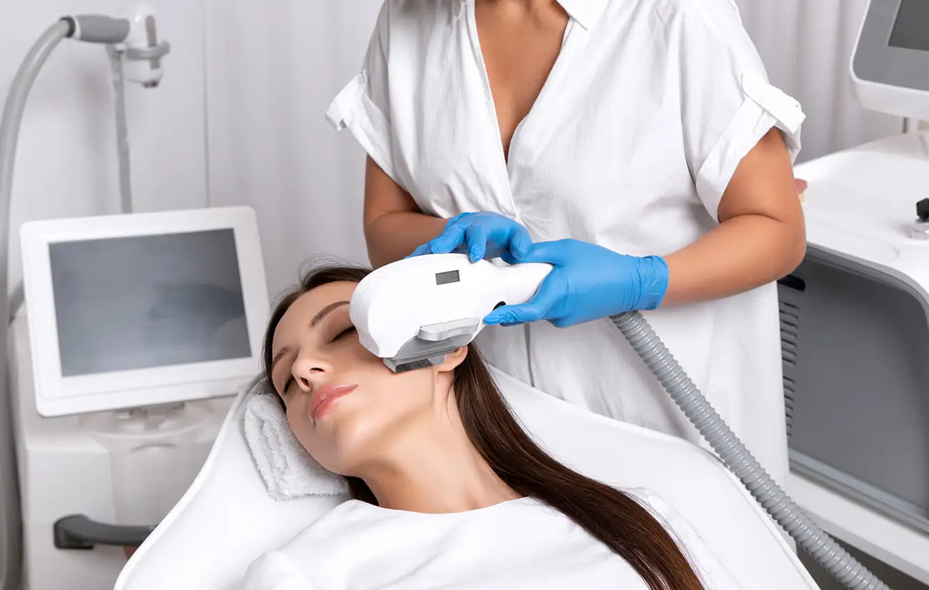 Photofacial treatment process – A close-up of an IPL photofacial treatment in progress, showing the Venus Versa device in action.